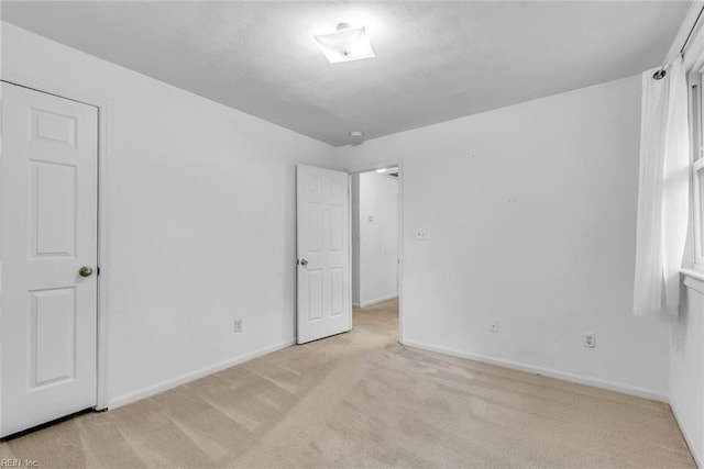 unfurnished bedroom with light colored carpet