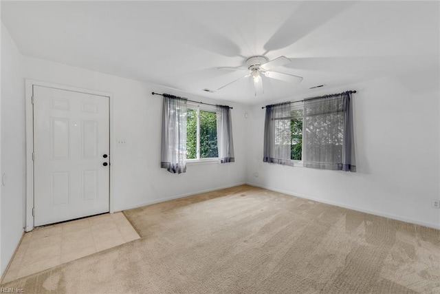 carpeted entrance foyer featuring ceiling fan