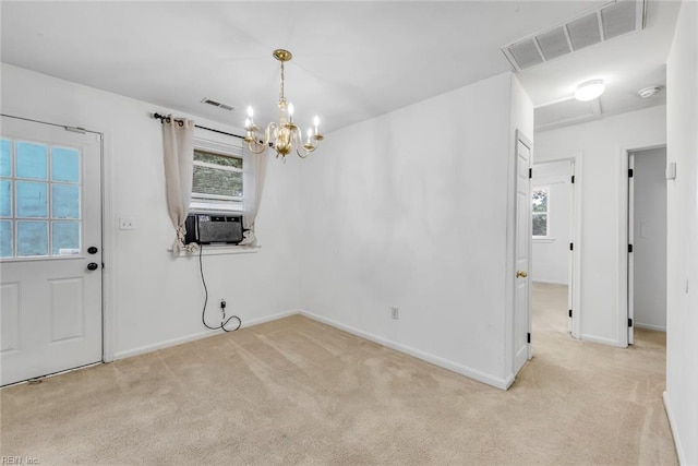 interior space featuring light carpet, cooling unit, a chandelier, and plenty of natural light