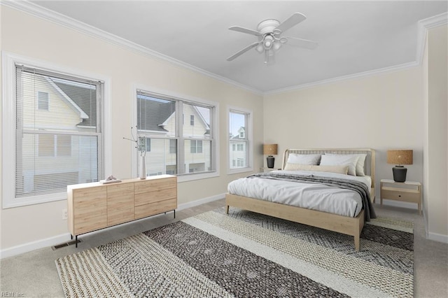 carpeted bedroom featuring ornamental molding and ceiling fan