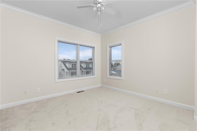 unfurnished room with ornamental molding, ceiling fan, and light colored carpet