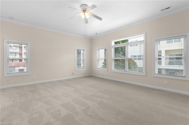 carpeted spare room with ornamental molding and ceiling fan