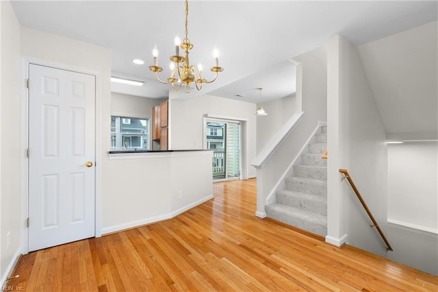 interior space with a chandelier and light hardwood / wood-style floors