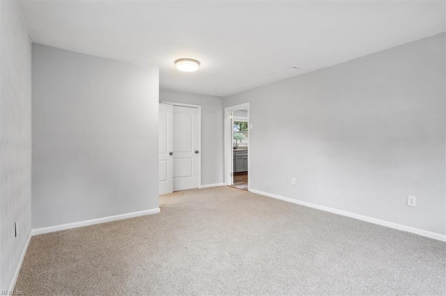 spare room with light carpet