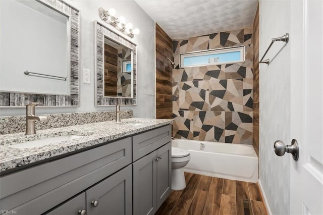 full bathroom featuring vanity, hardwood / wood-style flooring, shower / bath combination, and toilet