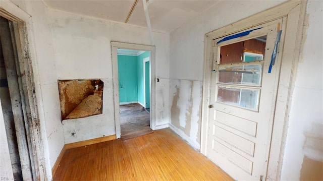 hallway with wood-type flooring