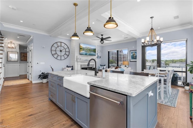 kitchen featuring a center island with sink, dishwasher, light wood-type flooring, and sink