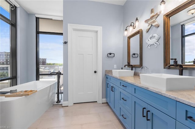 bathroom featuring a bath, tile patterned flooring, and vanity