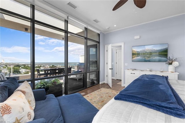 bedroom with ceiling fan, dark hardwood / wood-style floors, and expansive windows