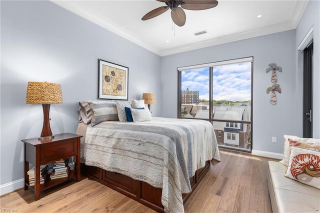 bedroom featuring ornamental molding, light hardwood / wood-style floors, and ceiling fan