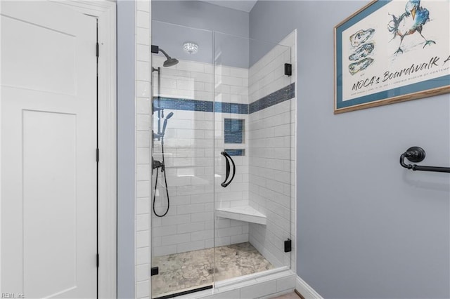 bathroom featuring a shower with door