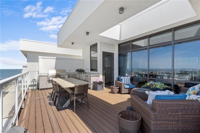 deck featuring sink, an outdoor living space, a grill, and a water view