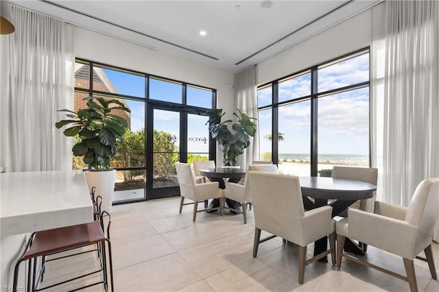 tiled dining space featuring a water view