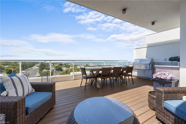 deck with a water view and grilling area