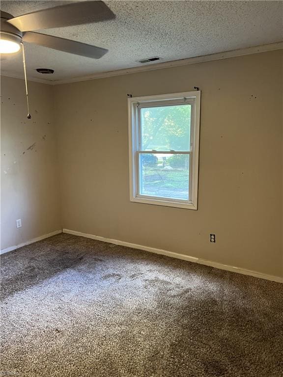 carpeted empty room with a textured ceiling, crown molding, and ceiling fan