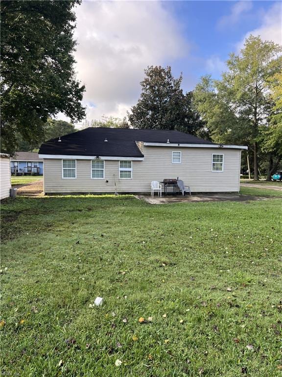 rear view of house with a patio area and a yard