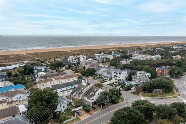 birds eye view of property featuring a water view and a beach view