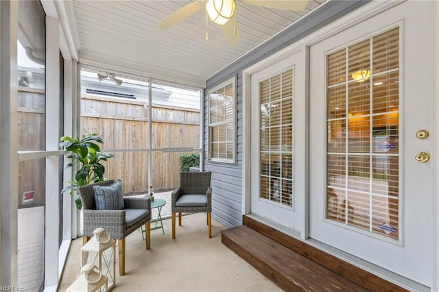 sunroom / solarium with wood ceiling and ceiling fan