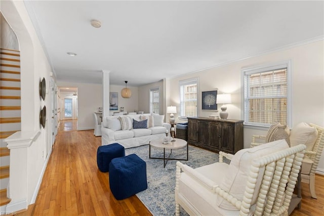 living room featuring ornamental molding and light hardwood / wood-style flooring