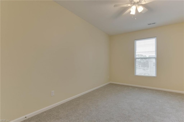 carpeted spare room with ceiling fan