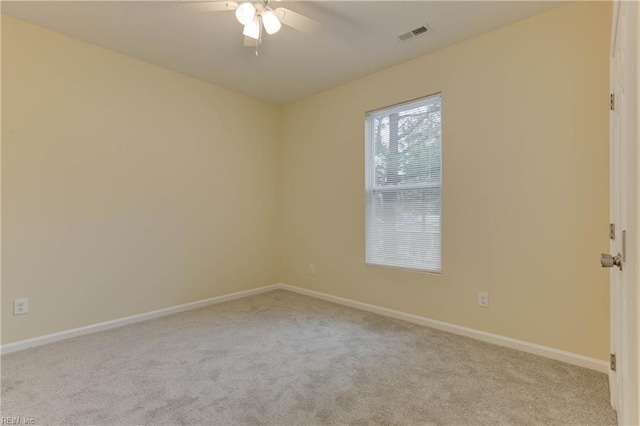 carpeted spare room featuring ceiling fan