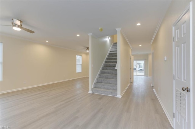 interior space featuring light wood-type flooring, ceiling fan, and crown molding