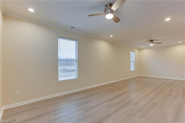 unfurnished room with ceiling fan, light wood-type flooring, and a healthy amount of sunlight