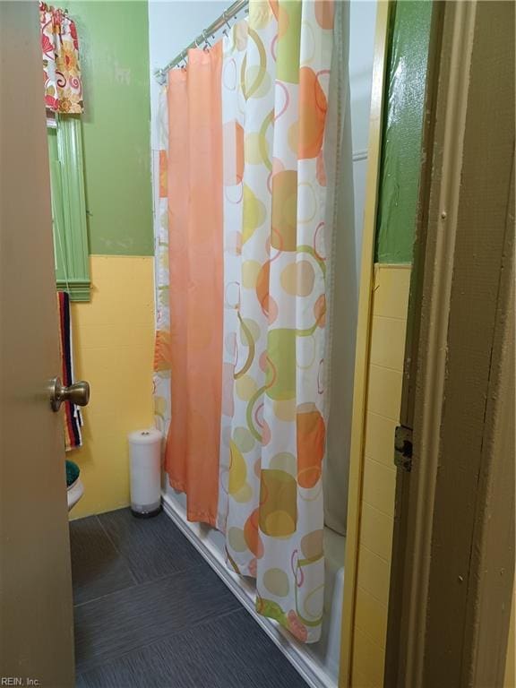 bathroom with tile patterned floors and a shower with shower curtain