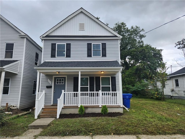 view of front facade featuring a front yard and covered porch