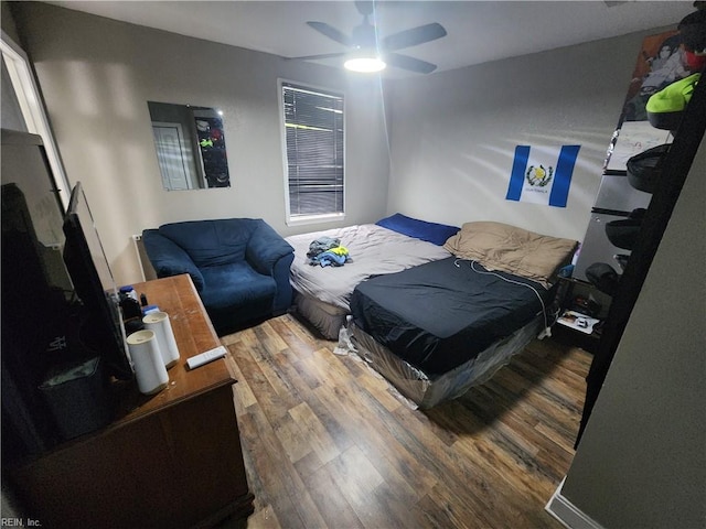 bedroom with hardwood / wood-style floors and ceiling fan