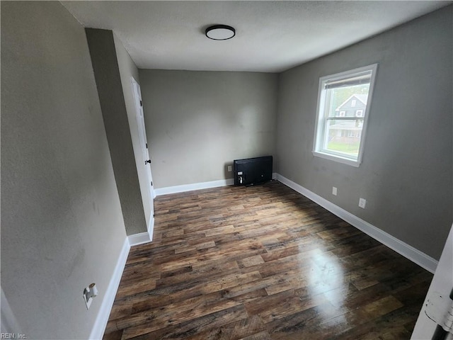 spare room featuring dark wood-type flooring