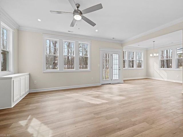 unfurnished living room with light wood-style floors, baseboards, a wealth of natural light, and ornamental molding