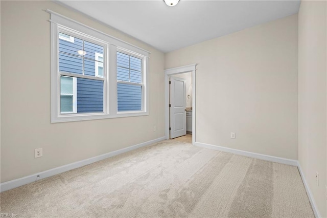 carpeted empty room with baseboards