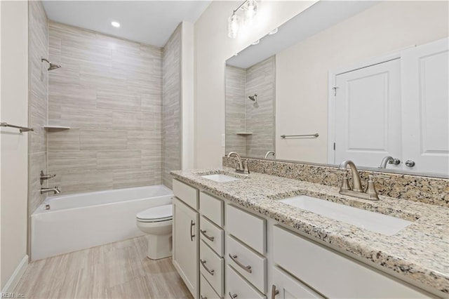 full bath featuring double vanity, toilet, shower / bathtub combination, and a sink