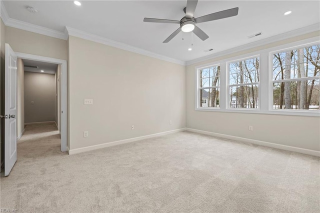 interior space with light carpet, baseboards, visible vents, and ornamental molding