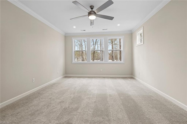 empty room with baseboards, a ceiling fan, light carpet, and crown molding