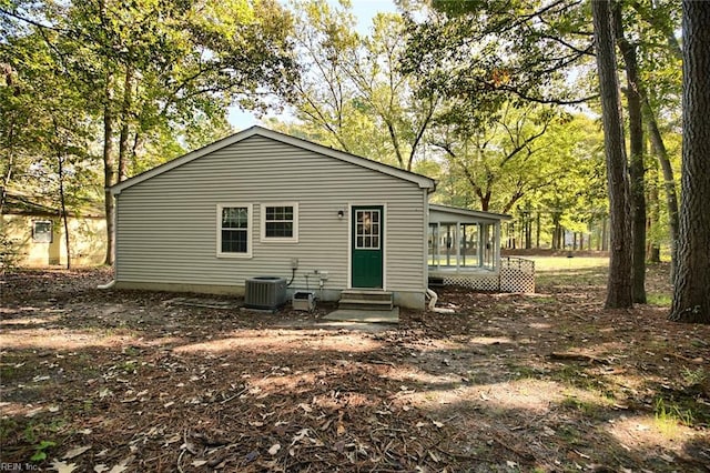 rear view of house featuring central AC