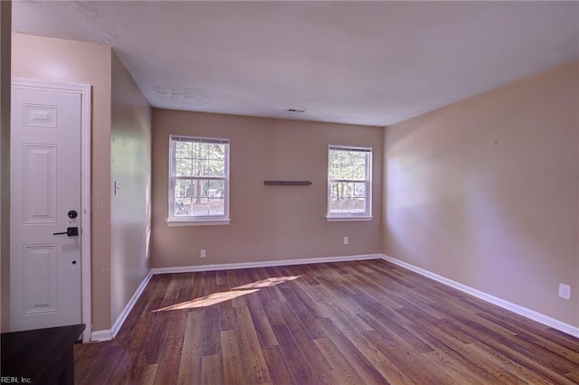 empty room featuring hardwood / wood-style floors and a wealth of natural light