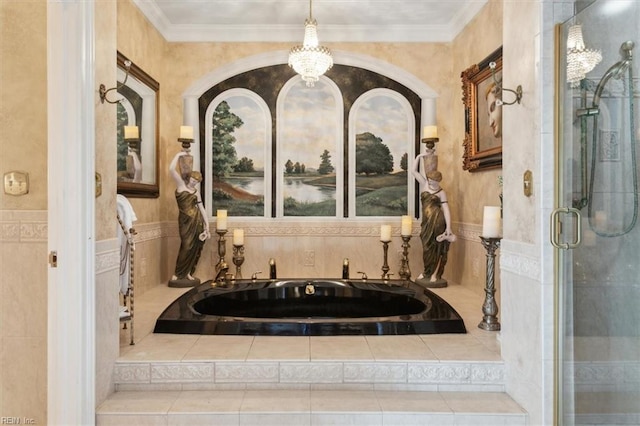 bathroom featuring independent shower and bath, a notable chandelier, and ornamental molding