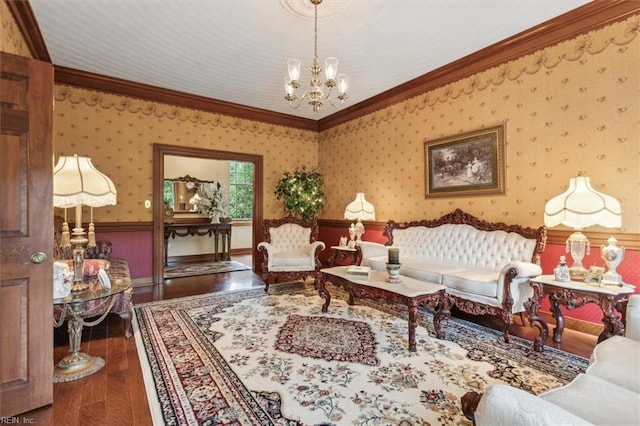 living room with an inviting chandelier, wood-type flooring, and crown molding