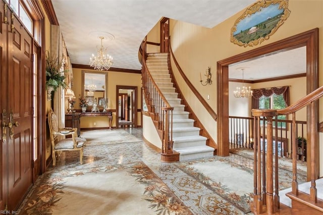 entryway with crown molding and a chandelier