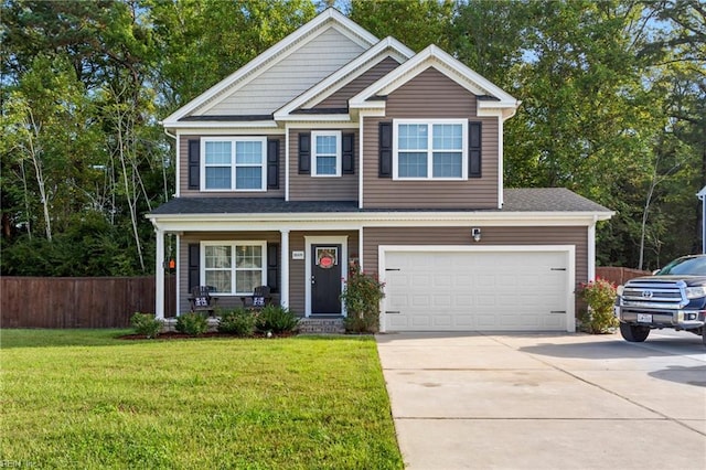 craftsman house with a front yard and a garage