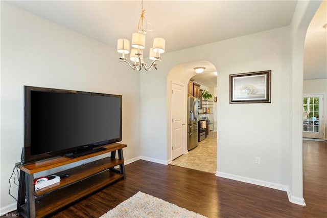 living room with an inviting chandelier and hardwood / wood-style floors