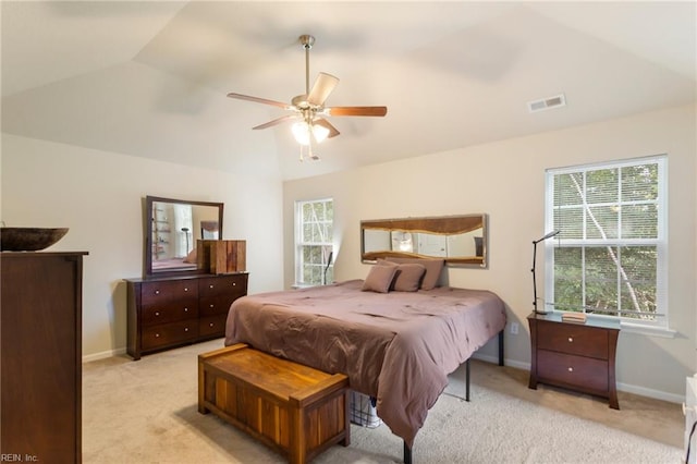 bedroom with ceiling fan, light carpet, and vaulted ceiling