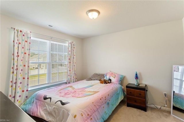 bedroom with light colored carpet