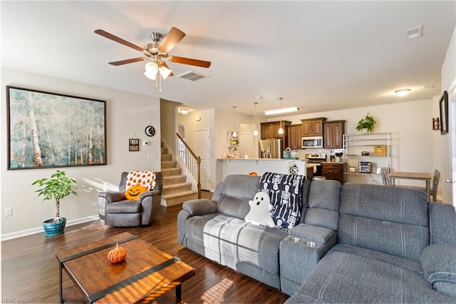 living room featuring ceiling fan and dark hardwood / wood-style floors