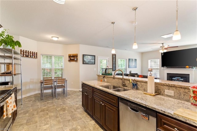 kitchen with decorative light fixtures, plenty of natural light, sink, and stainless steel dishwasher