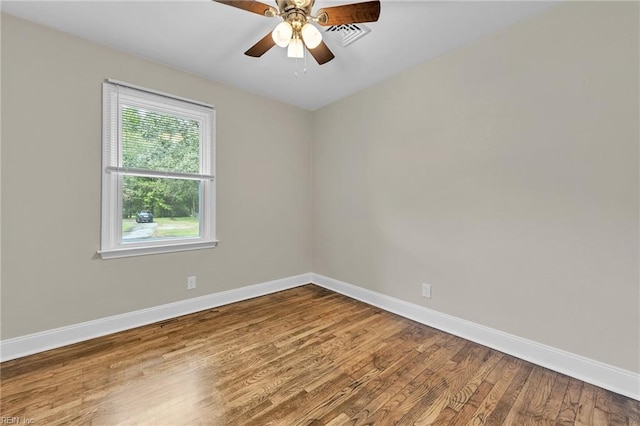 unfurnished room with ceiling fan and hardwood / wood-style flooring