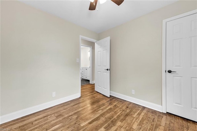 unfurnished bedroom with ceiling fan and hardwood / wood-style flooring