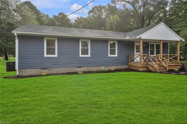 rear view of property with a deck and a yard